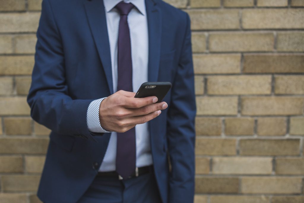 a man in a suit holding a phone