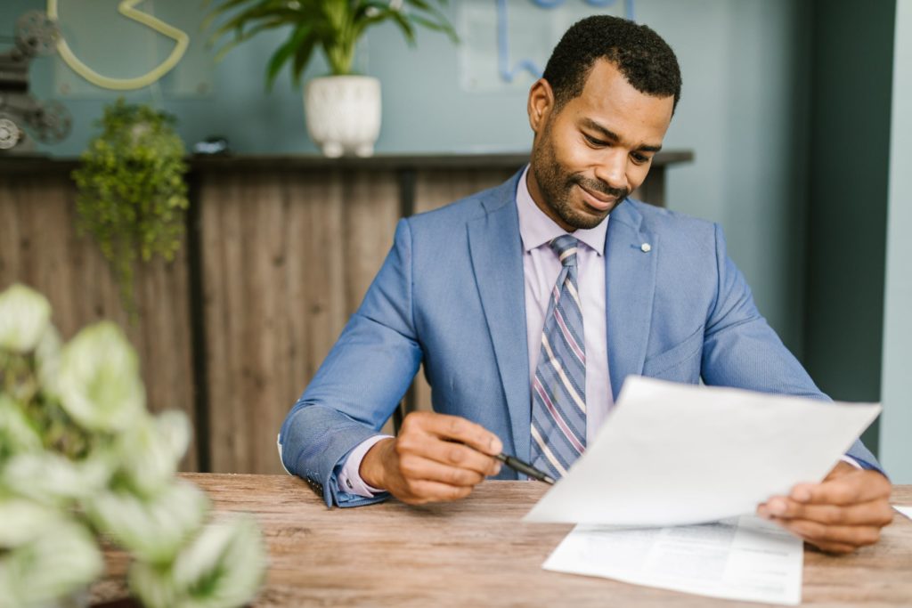 a man sitting at a table writing