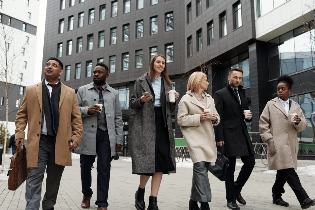 a group of people walking on a sidewalk