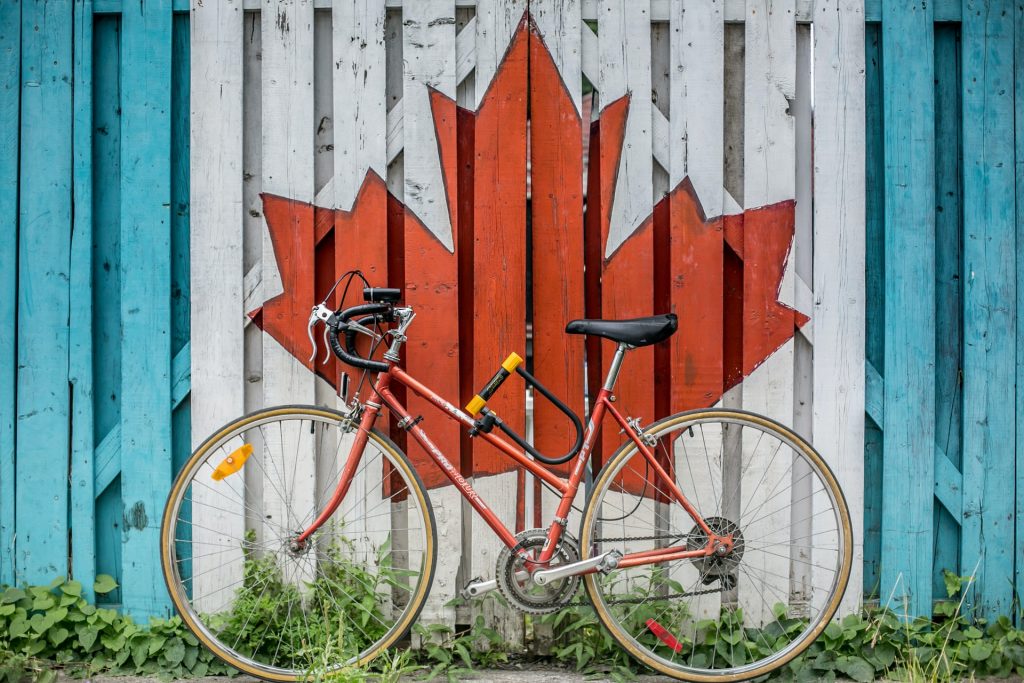 a bicycle leaning against a white wall