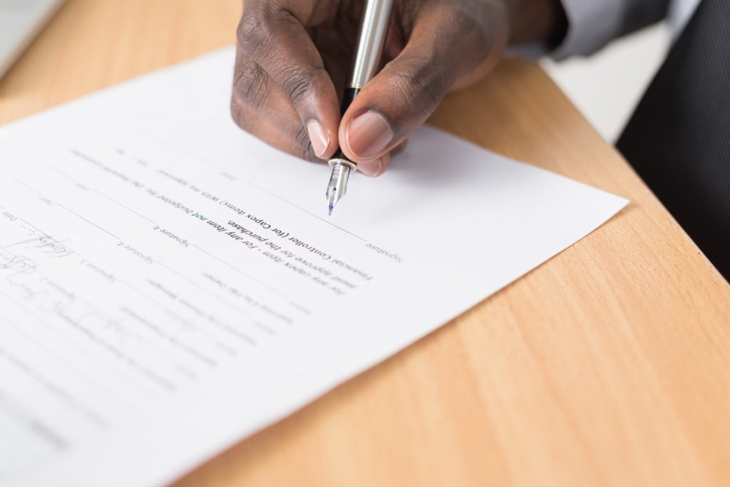 a person writing on a piece of paper