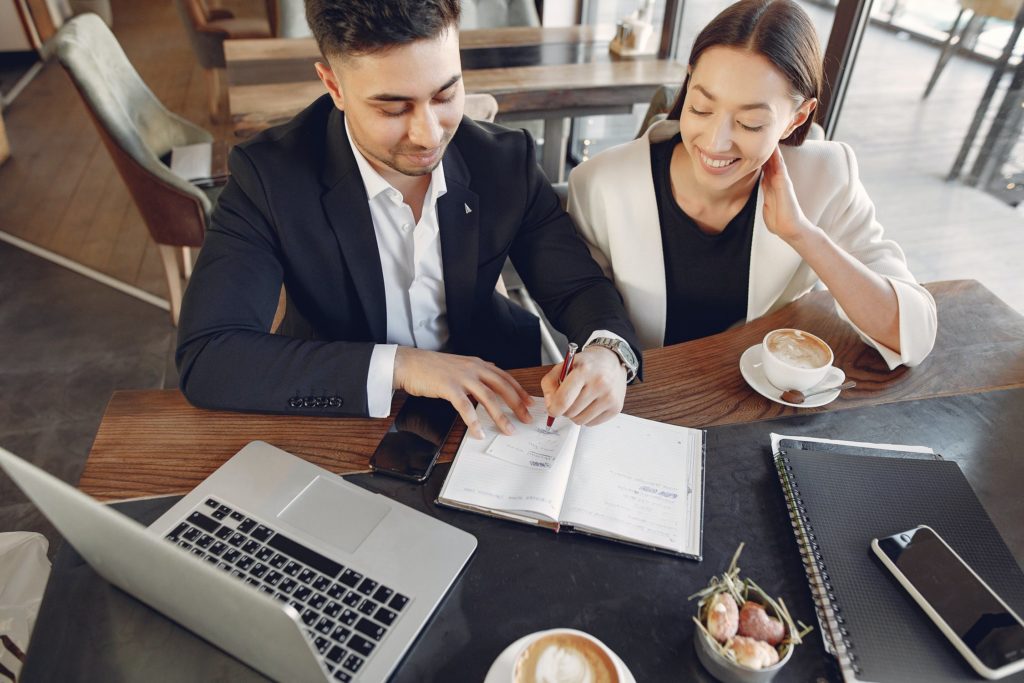 a man and a woman looking at a paper