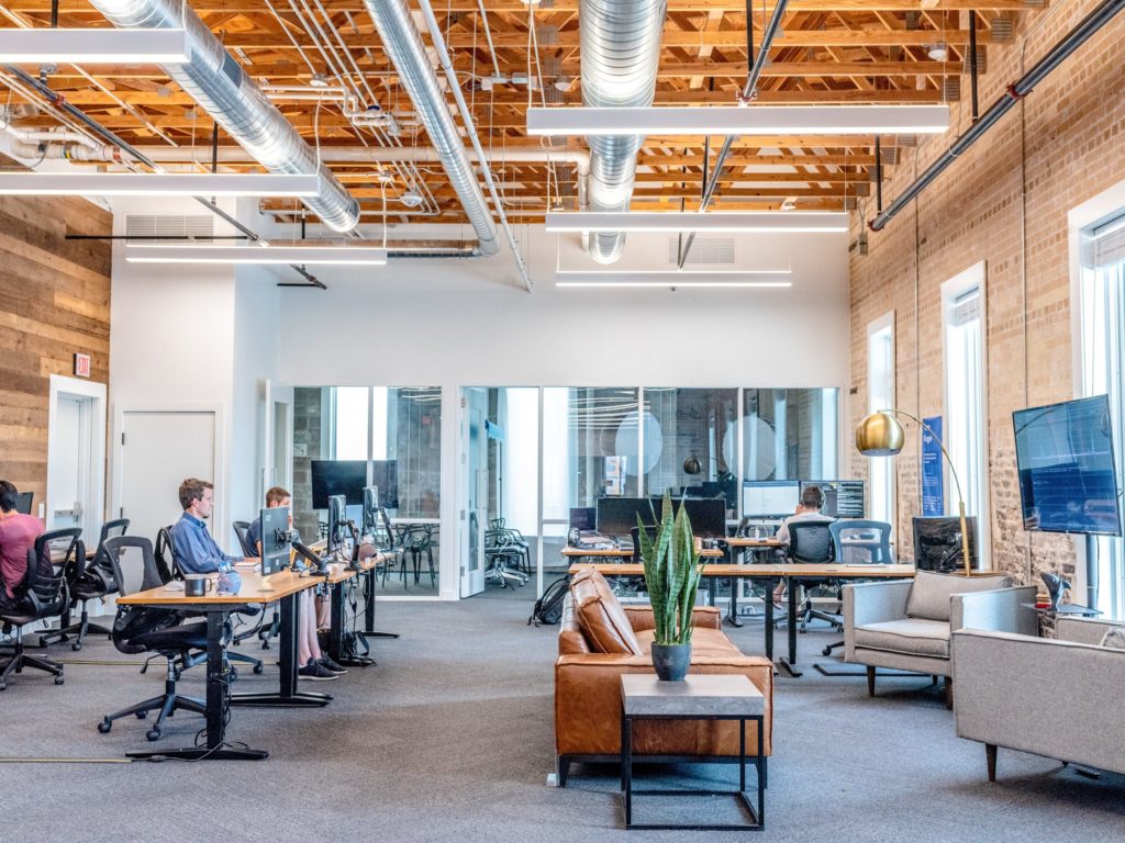 a room with people sitting at tables and chairs