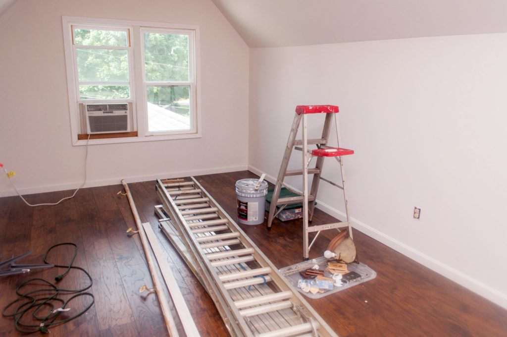 a room with a ladder and a window