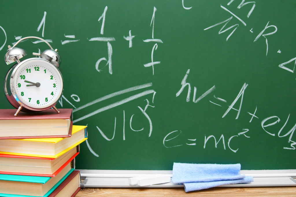 a green chalkboard with a clock