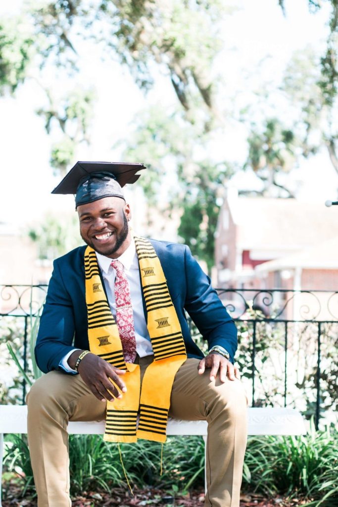 a man wearing a graduation cap and gown