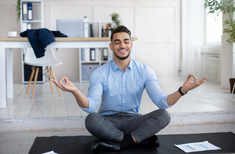 MAN DOING YOGA AT HIS OFFICE