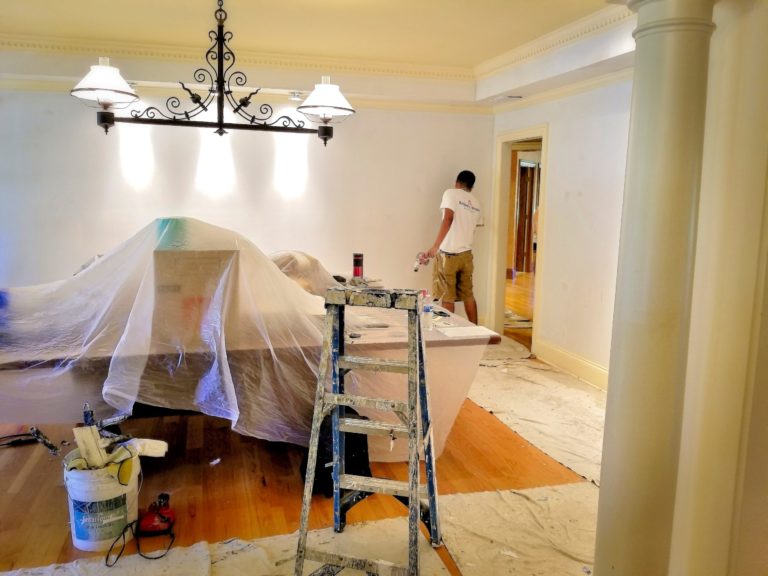 Painters paint a room during a remodel